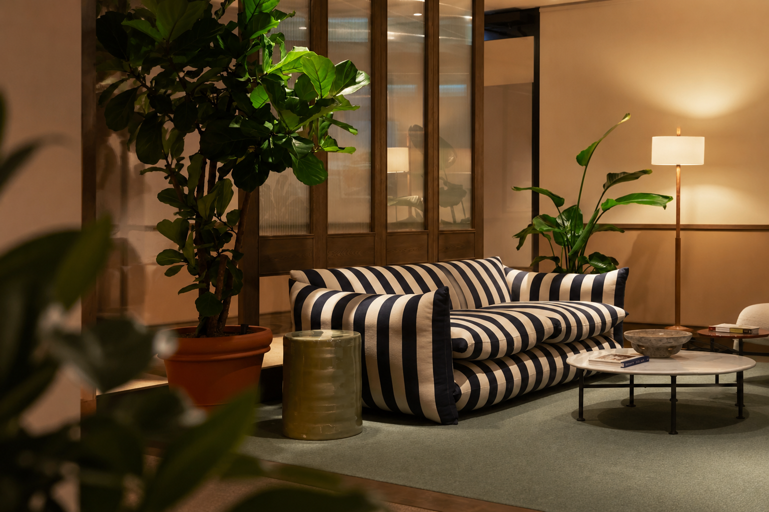 Contemporary planted workspace featuring integrated greenery and a striped sofa seating area.