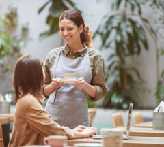 Waitress Bringing Coffee On Outdoor Cafe Terrace
