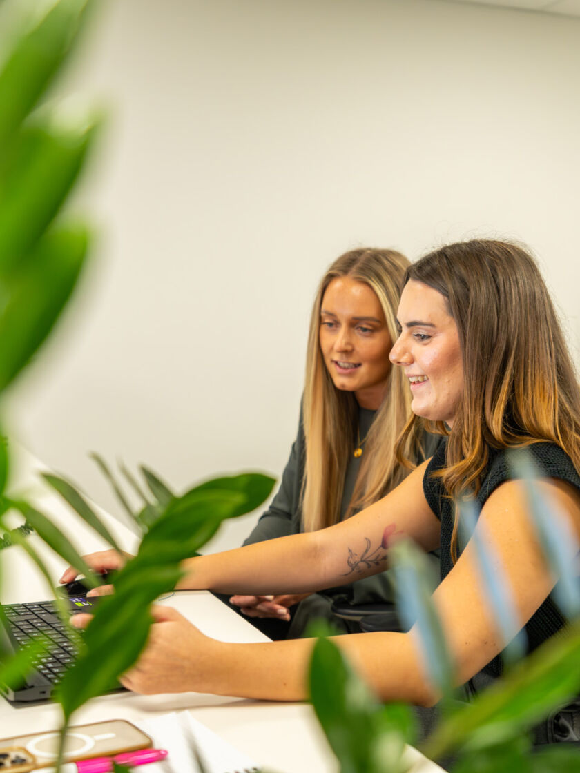 Medium shot of two Exubia female designers within a contemporary workplace environment.