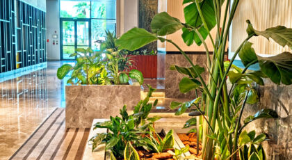 Modern Interior Design Featuring Indoor Plants And Natural Light In A Luxurious Hotel Lobby