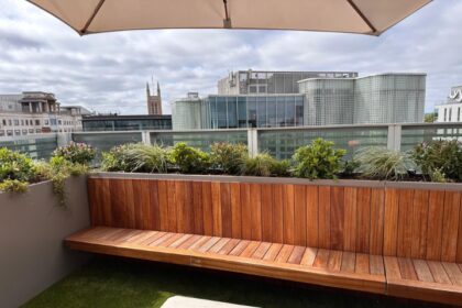 Bespoke wooden bench with integrated planting on a city rooftop terrace